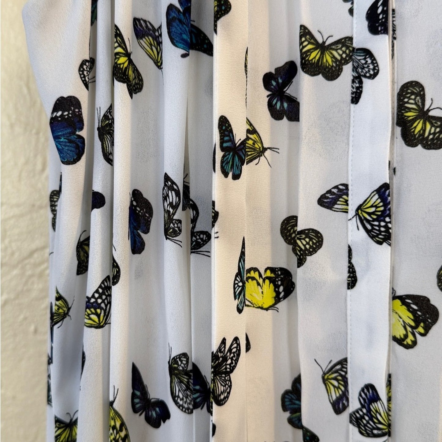 White Sleeveless Button-Down Blouse with Butterfly Print